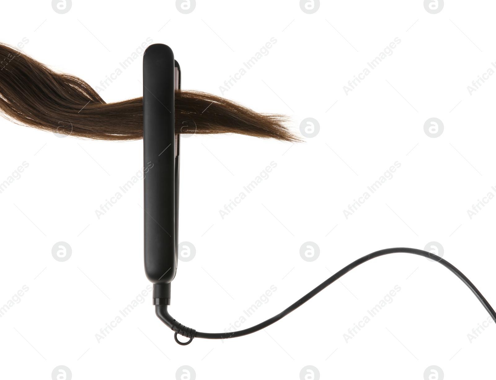 Photo of Brown hair and flat iron isolated on white