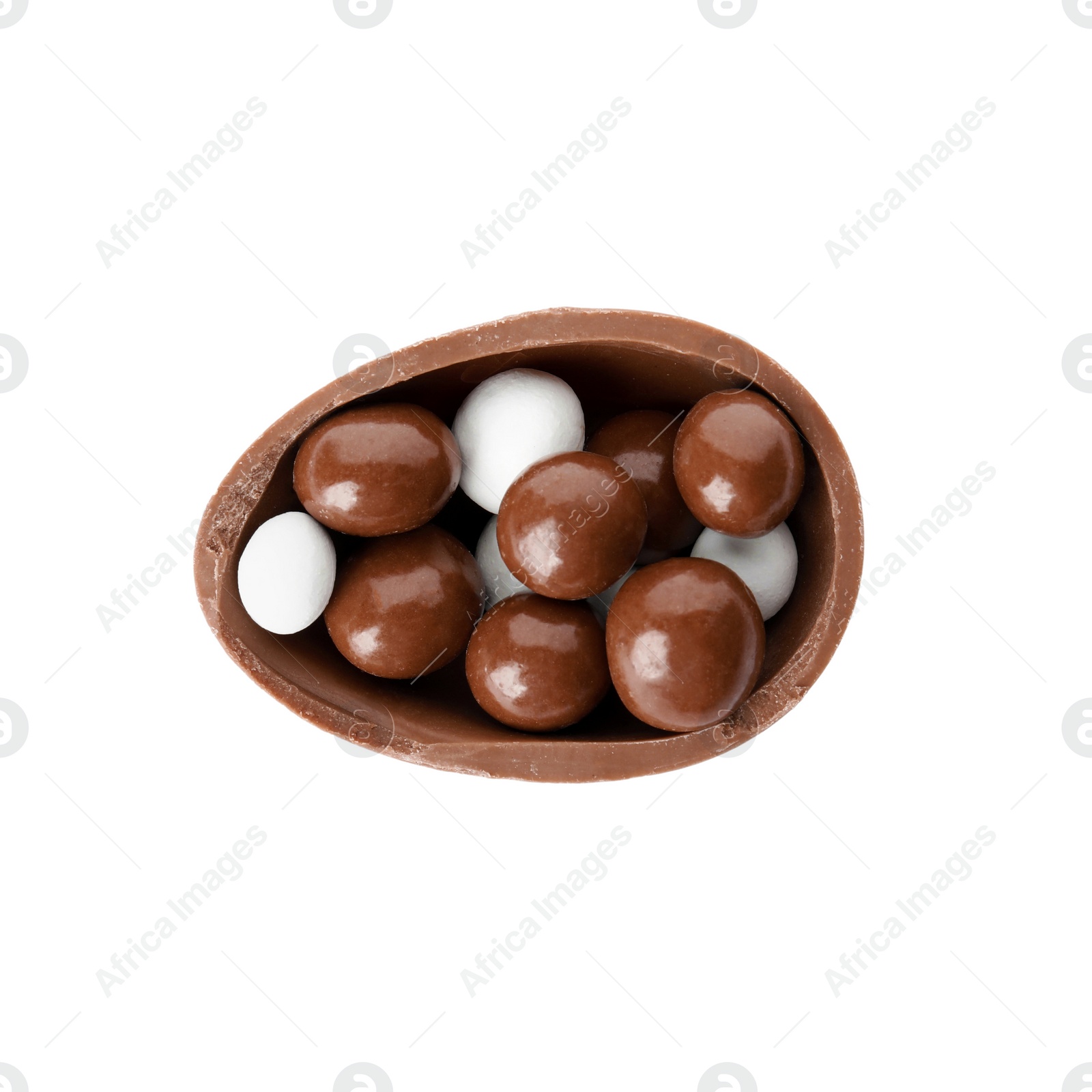 Photo of Half of tasty chocolate egg with candies on white background, top view