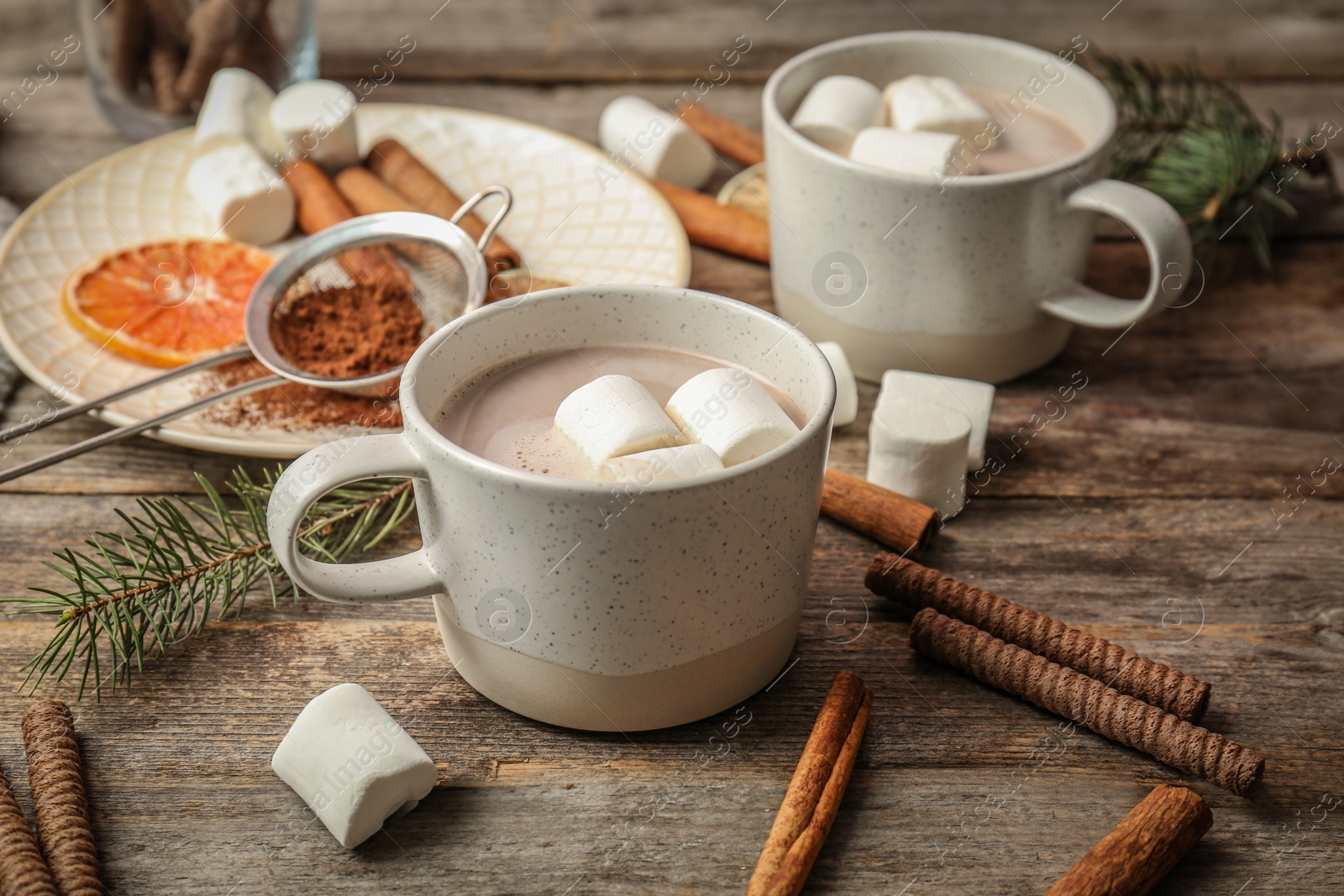 Photo of Cup with delicious hot cocoa drink on table