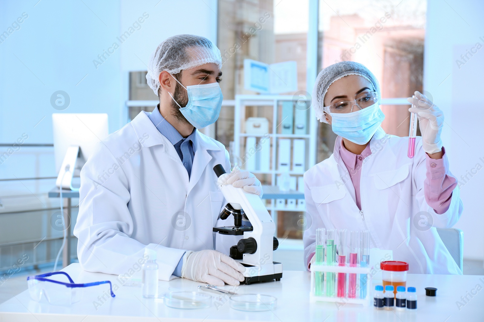 Photo of Young scientists working in laboratory. Chemical analysis