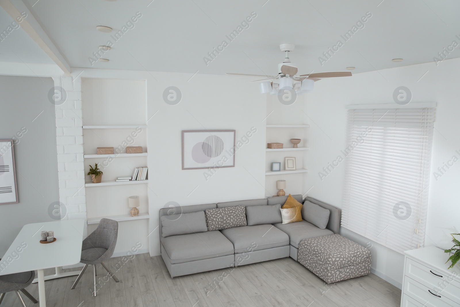 Photo of Ceiling fan, furniture and accessories in stylish living room, above view