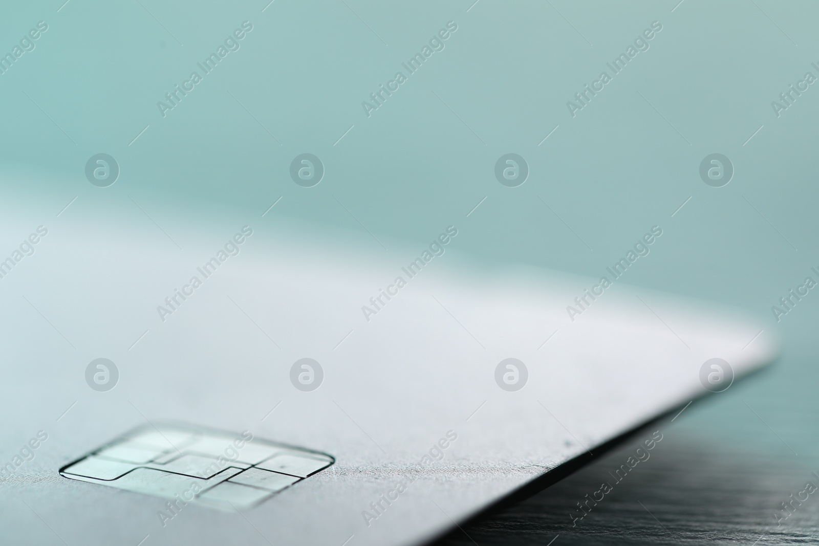 Photo of One credit card on color background, macro view. Space for text