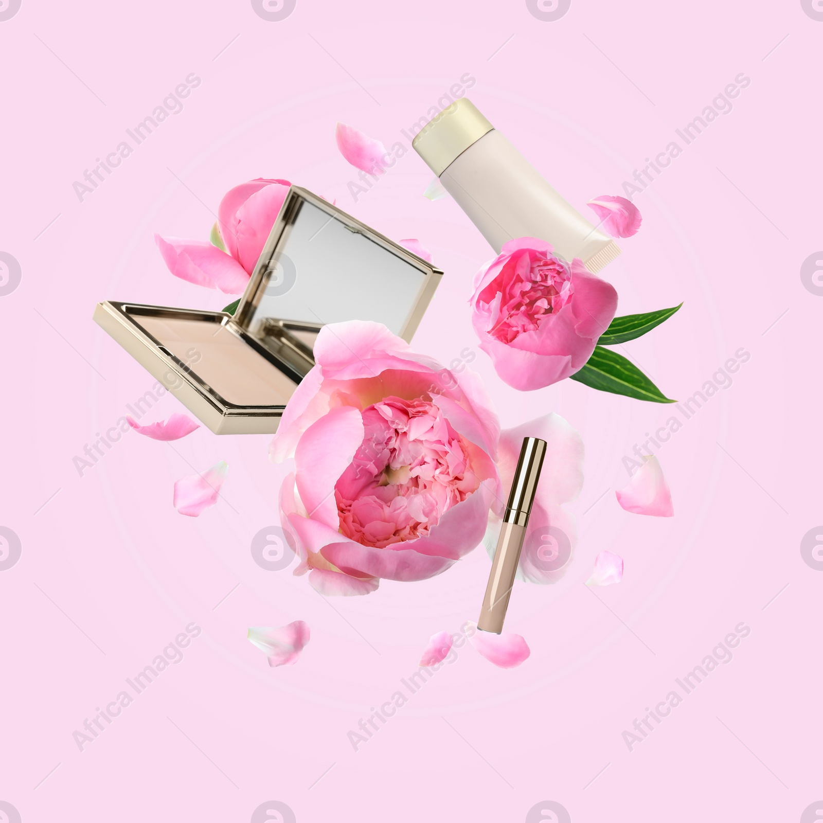 Image of Spring flowers and makeup products in air on pink background