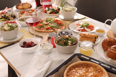 Many different dishes served on buffet table for brunch