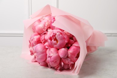 Bouquet of beautiful pink peonies on white table