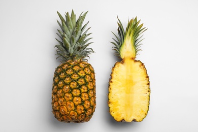 Photo of Tasty raw cut pineapples on white background, top view