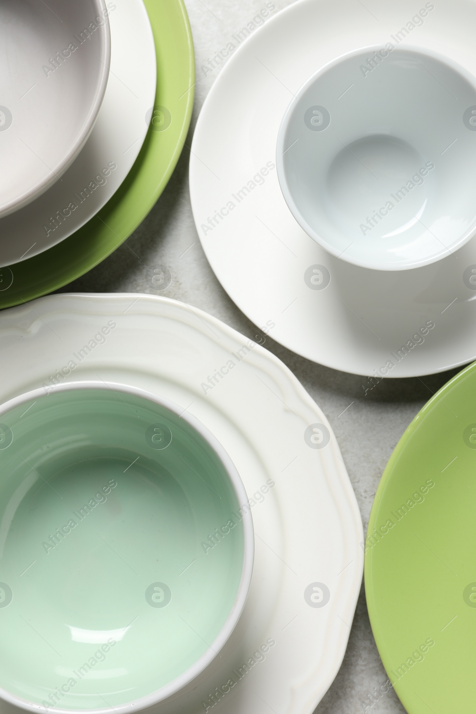 Photo of Beautiful ceramic dishware on light grey table, flat lay