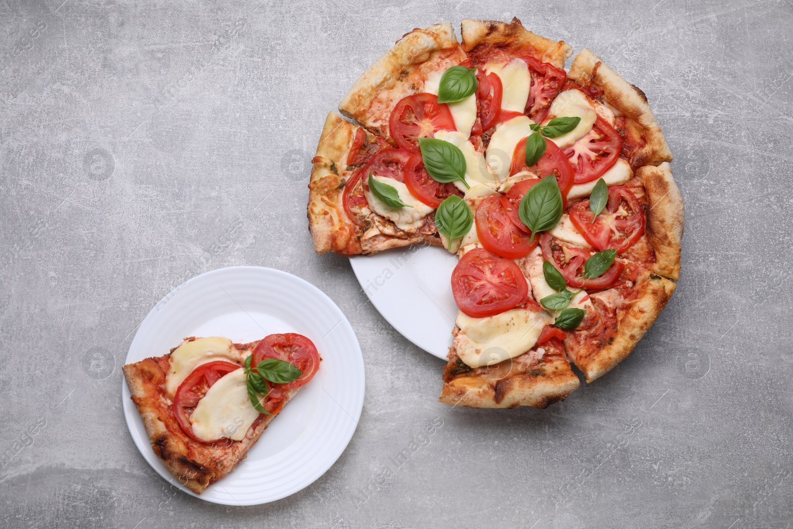 Photo of Delicious Caprese pizza on grey table, flat lay