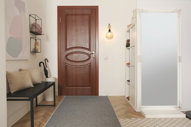 Modern hallway interior with stylish furniture and mirror