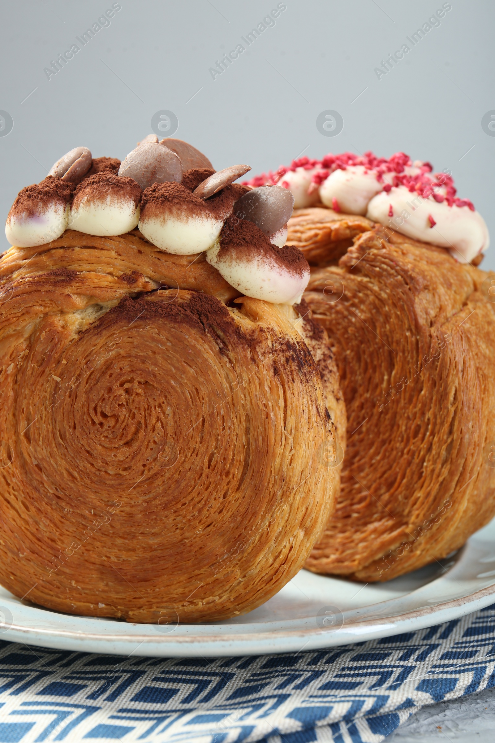 Photo of Crunchy round croissants on table, closeup. Tasty puff pastry