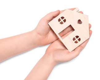 Home security concept. Little child holding house model on white background, top view