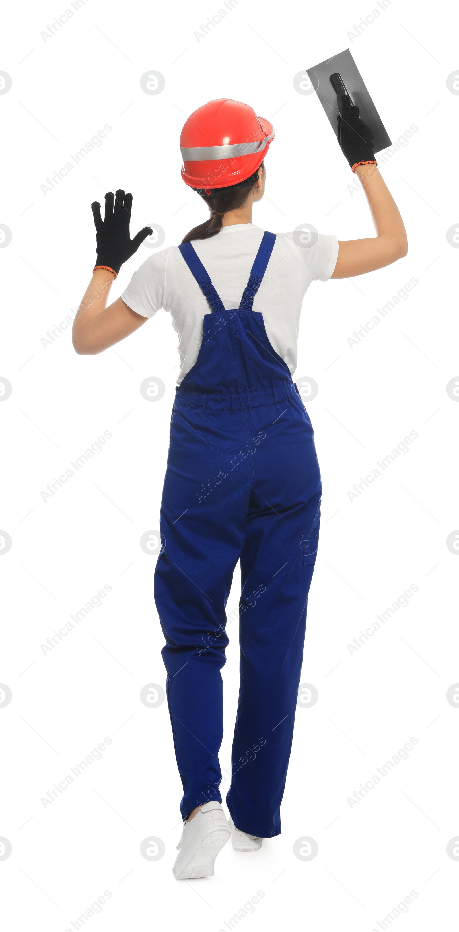 Photo of Professional worker with putty knife on white background, back view