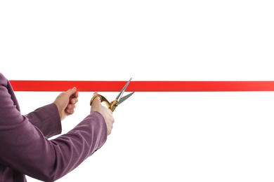 Photo of Woman in office suit cutting red ribbon isolated on white, closeup