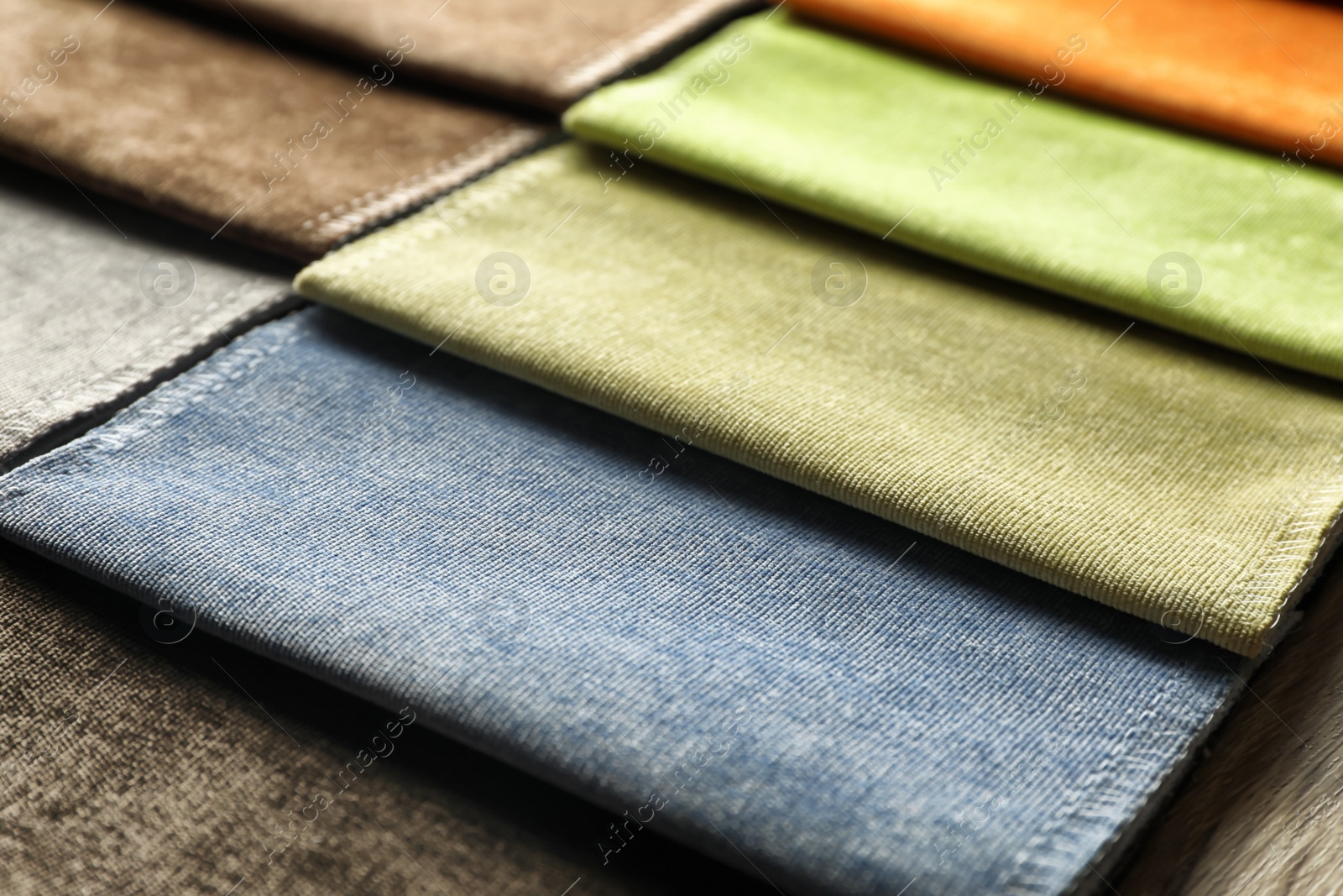 Photo of Fabric samples of different colors for interior design as background