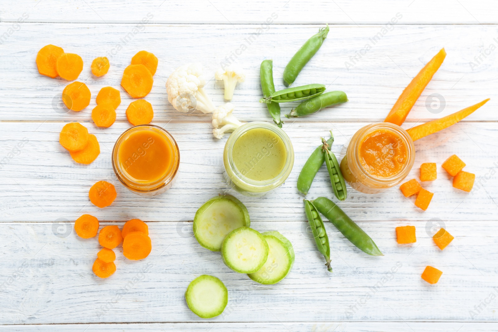 Photo of Flat lay composition with baby food and ingredients on wooden background