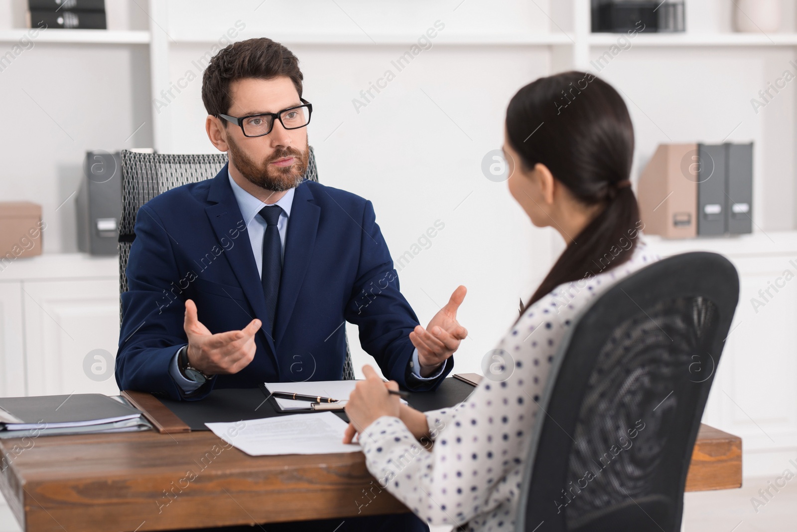 Photo of Woman having meeting with lawyer in office, selective focus