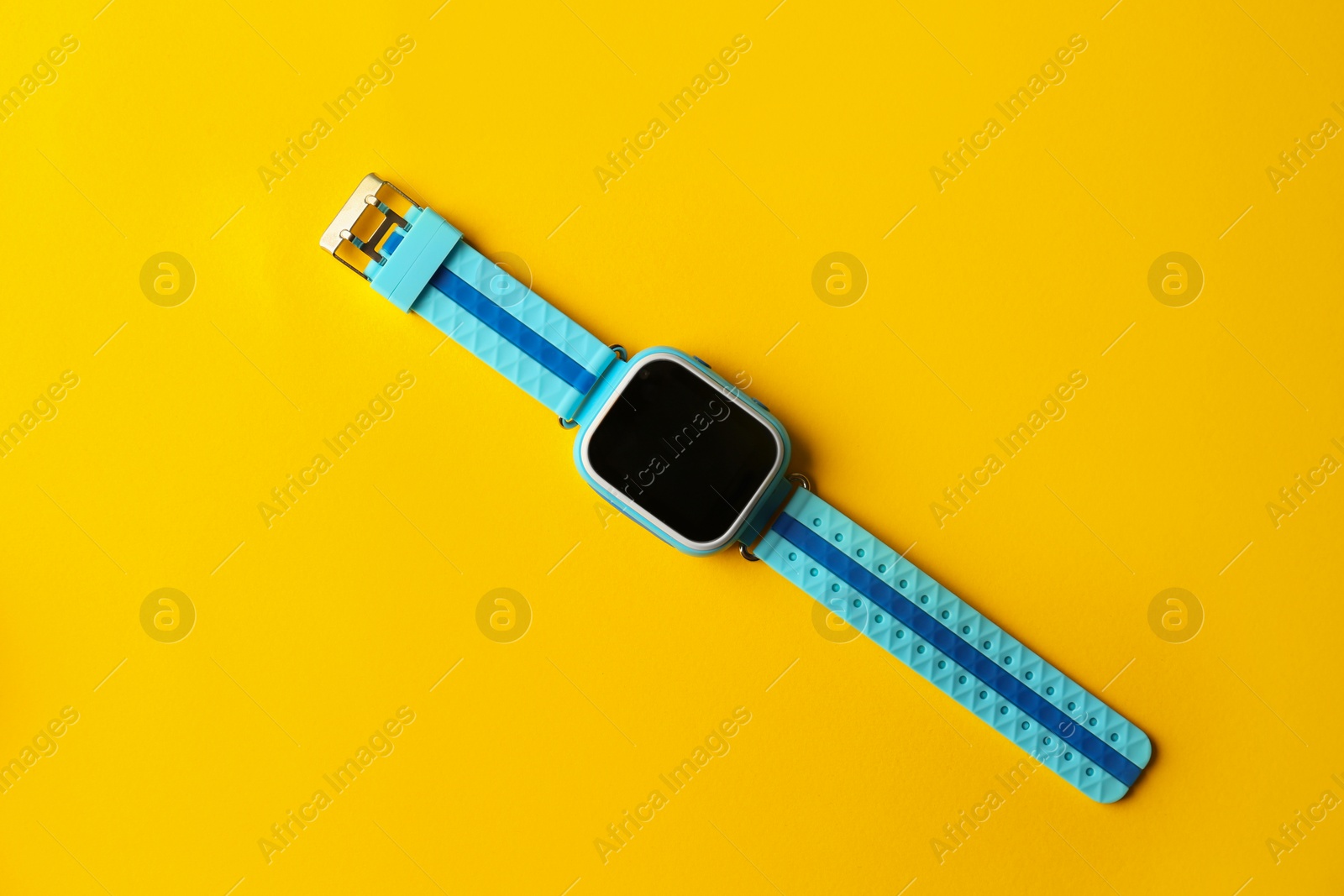 Photo of Trendy smart watch for kids on yellow background, top view