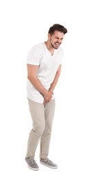 Young man with urological problems suffering from pain on white background