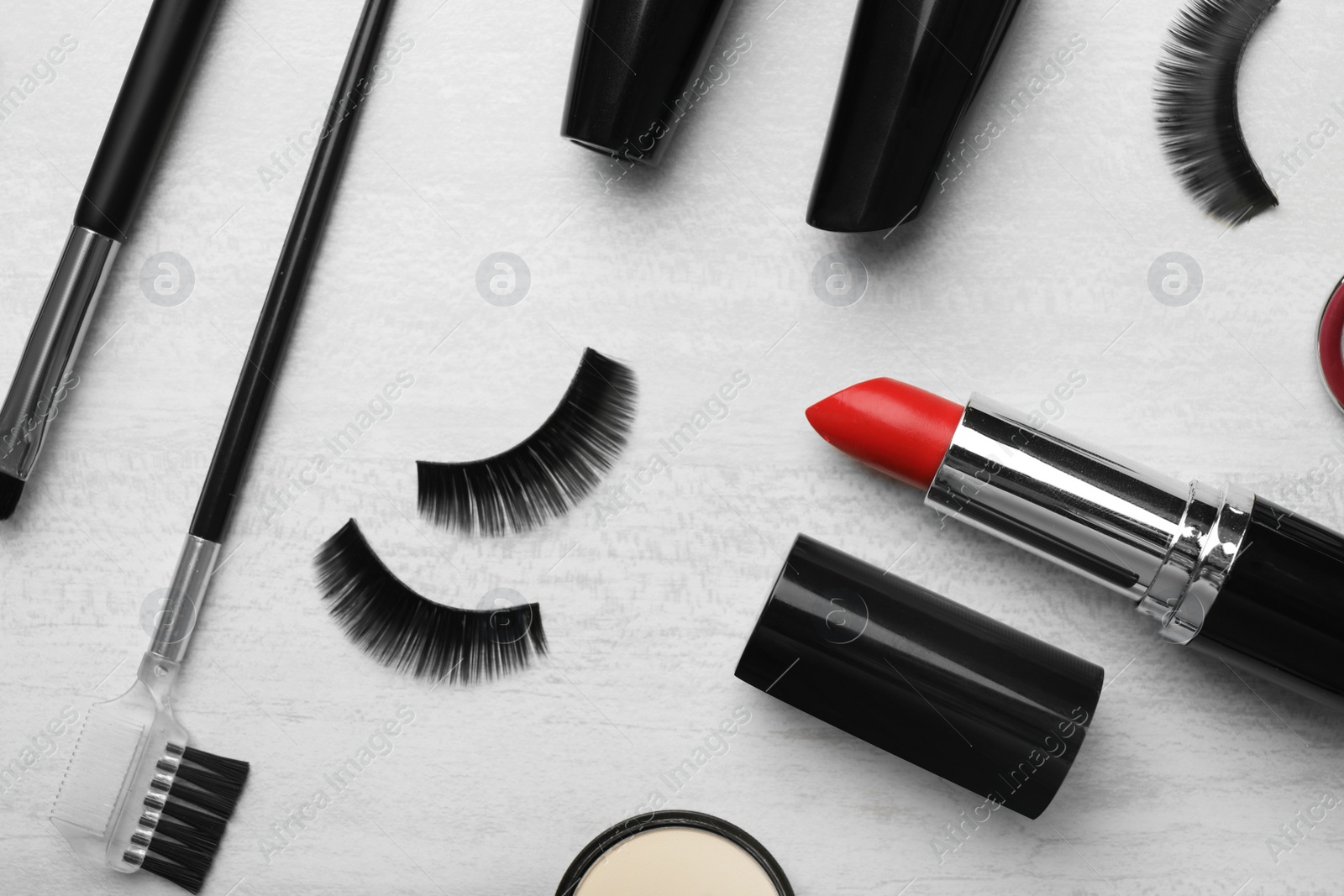 Photo of Flat lay composition with artificial eyelashes and accessories on light background