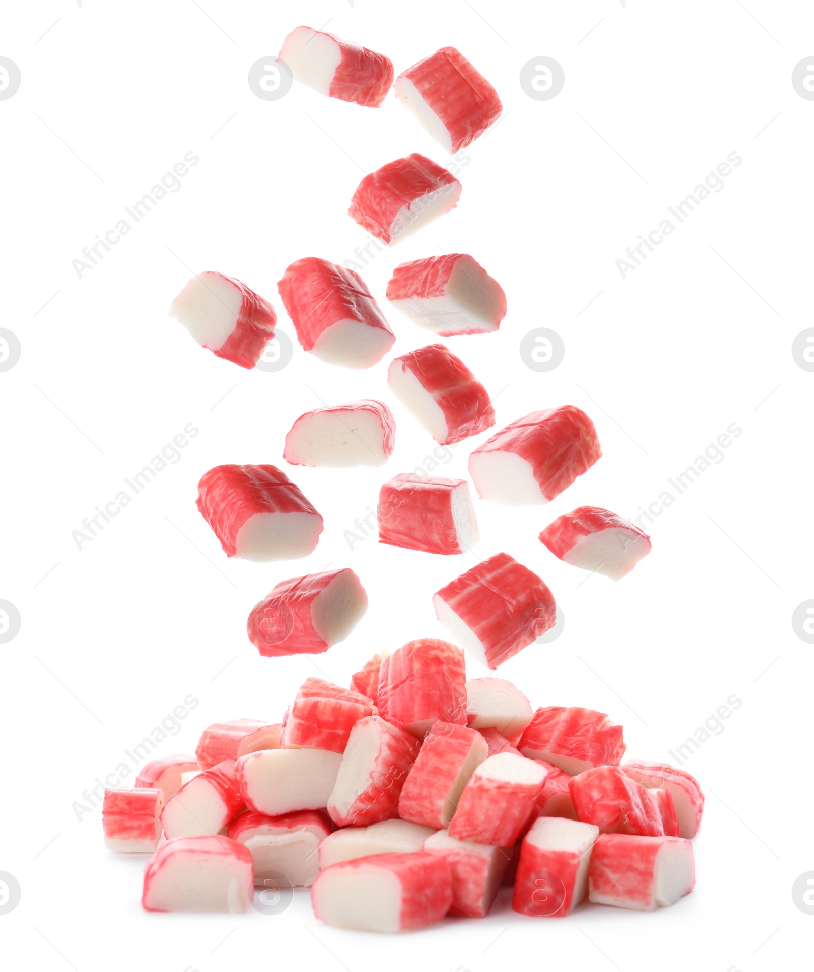 Image of Cut fresh crab sticks falling on white background