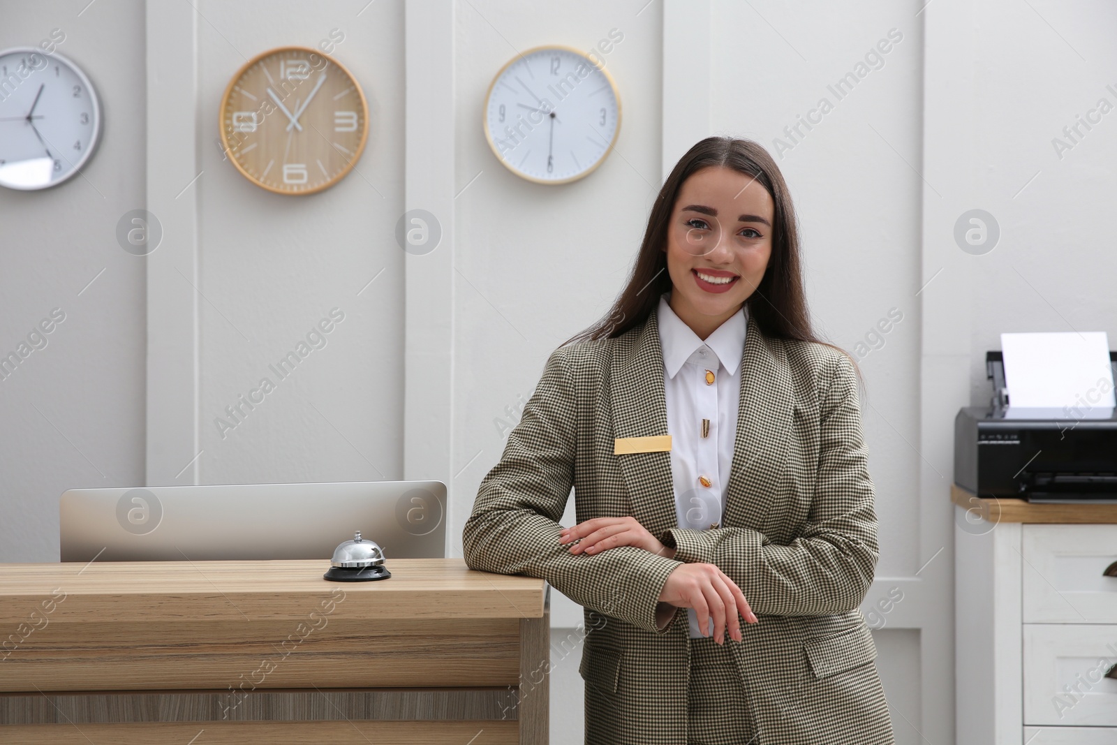 Photo of Portrait of beautiful receptionist near counter in hotel