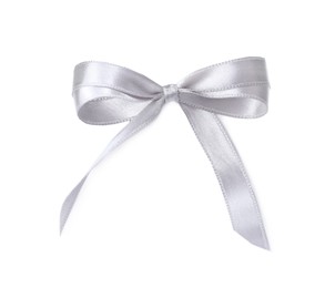 Photo of Silver satin ribbon tied in bow on white background, top view