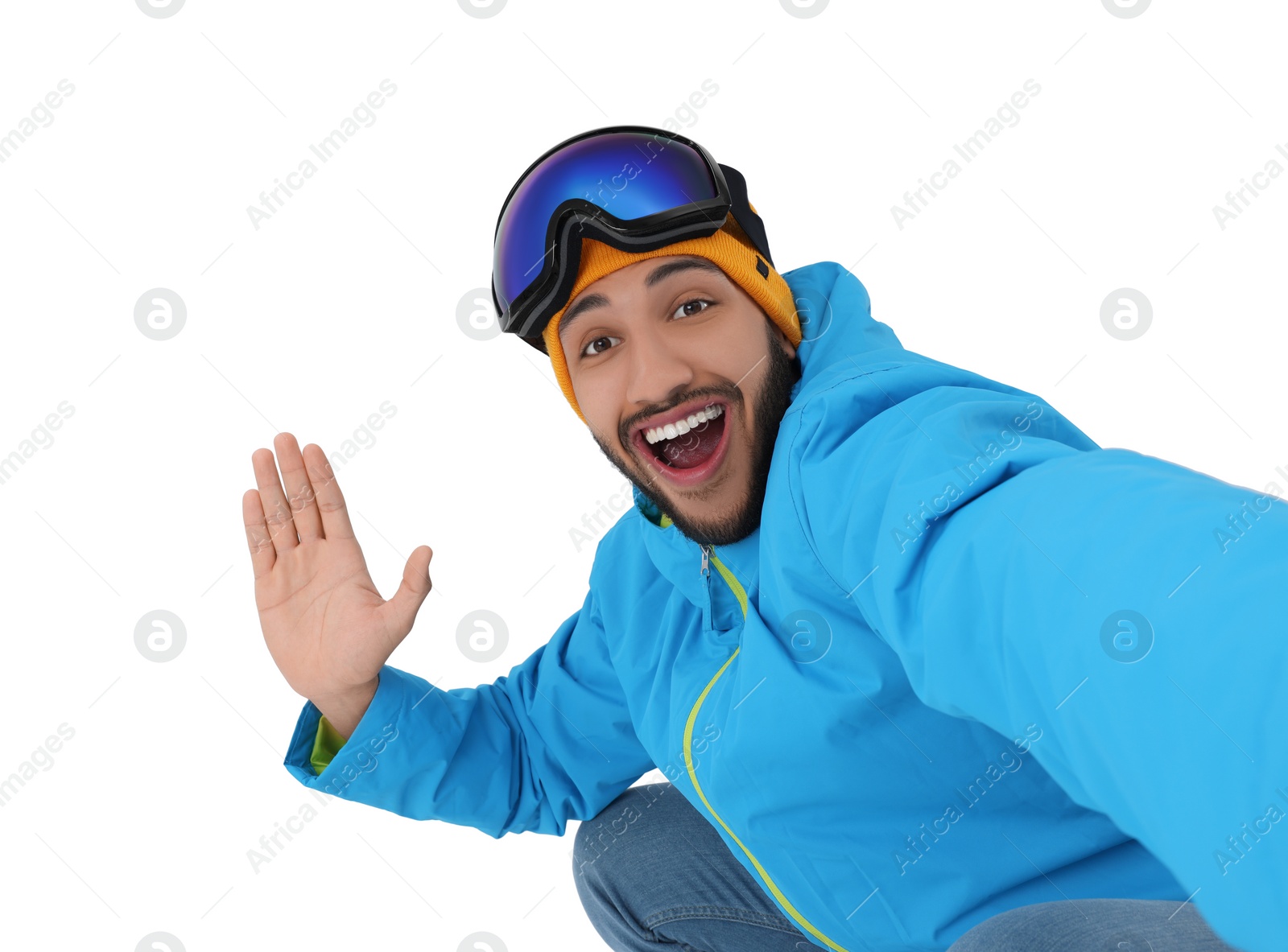 Photo of Smiling young man with ski goggles taking selfie on white background