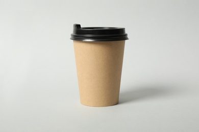 Photo of Takeaway paper coffee cup on light grey background