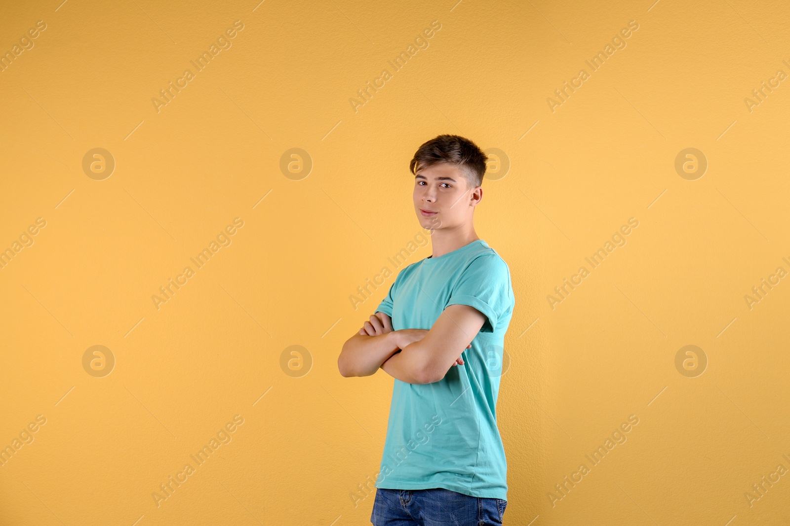 Photo of Teenage boy in casual clothes on color background