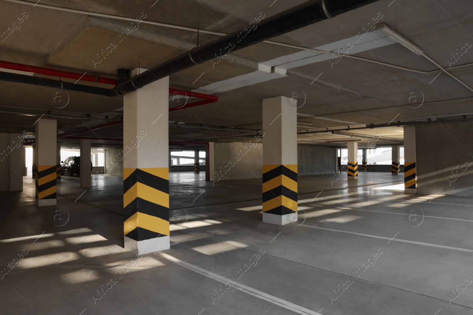 Photo of Open parking garage with car on sunny day