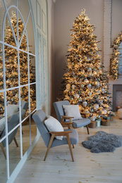 Photo of Festive room interior with stylish furniture and beautiful Christmas tree