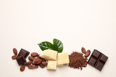 Photo of Flat lay composition with organic cocoa butter on beige background. Space for text