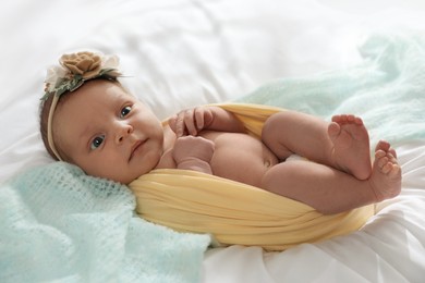 Photo of Adorable newborn baby lying on bed indoors