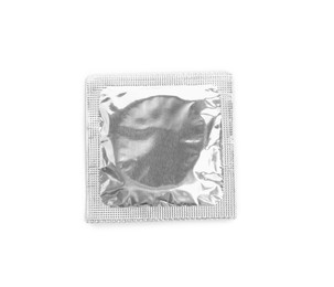 Photo of Condom package isolated on white, top view. Safe sex