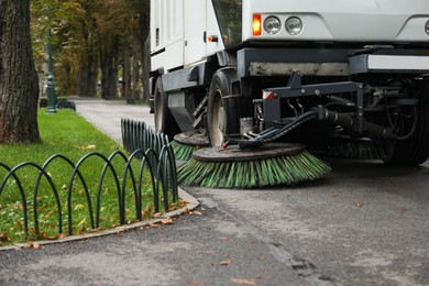 Sweeping car in park on autumn day