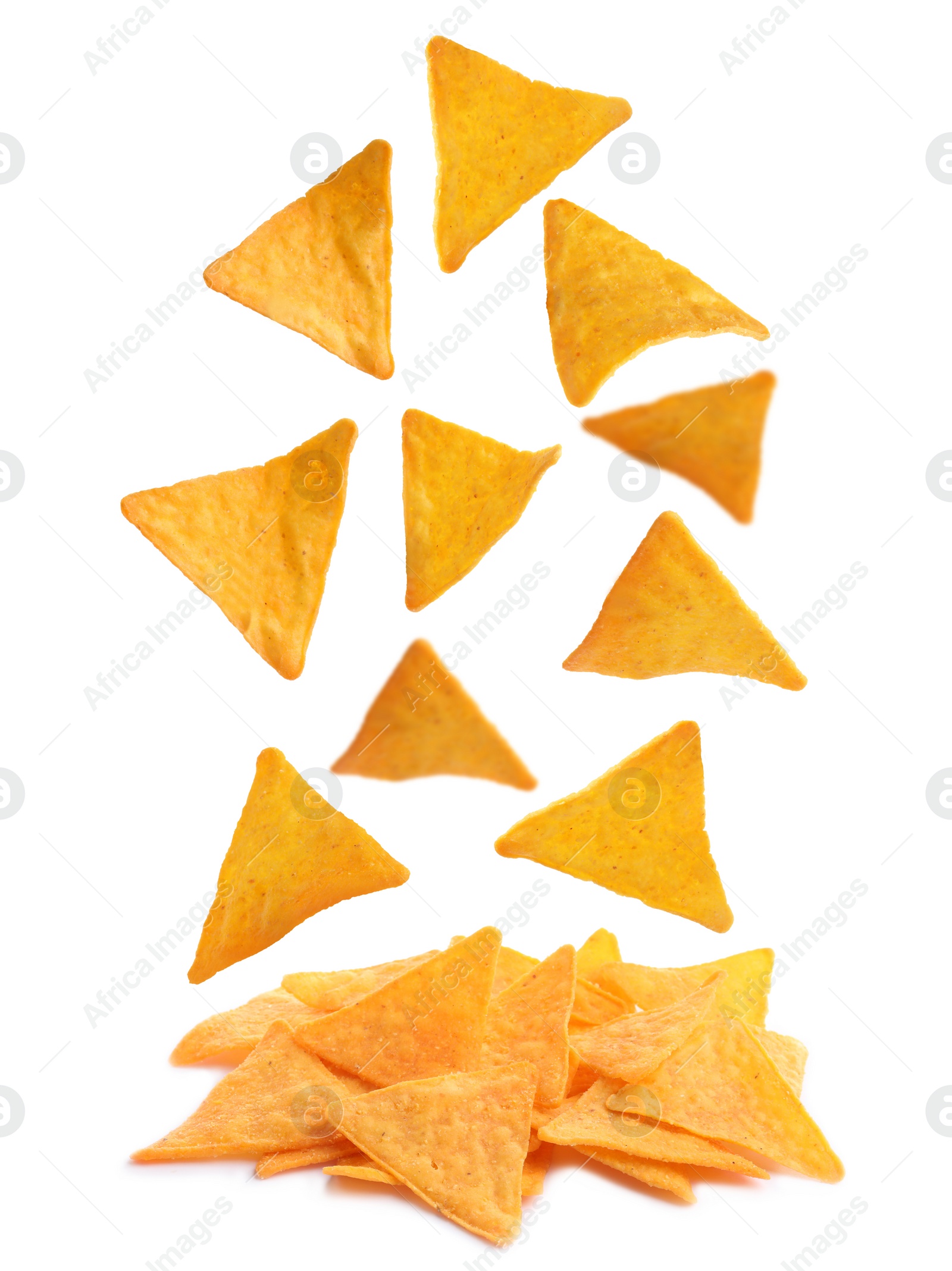 Tasty tortilla chips (nachos) falling into pile on white background ...