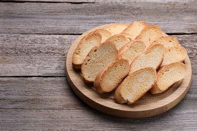 Photo of Tasty hard chuck crackers on wooden table