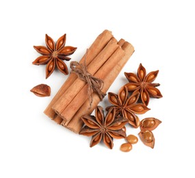 Dry anise stars and cinnamon sticks on white background, top view