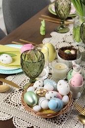 Festive table setting with painted eggs. Easter celebration