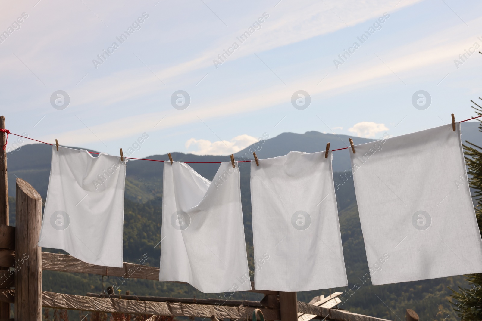 Photo of Laundry with clothes pins on line outdoors