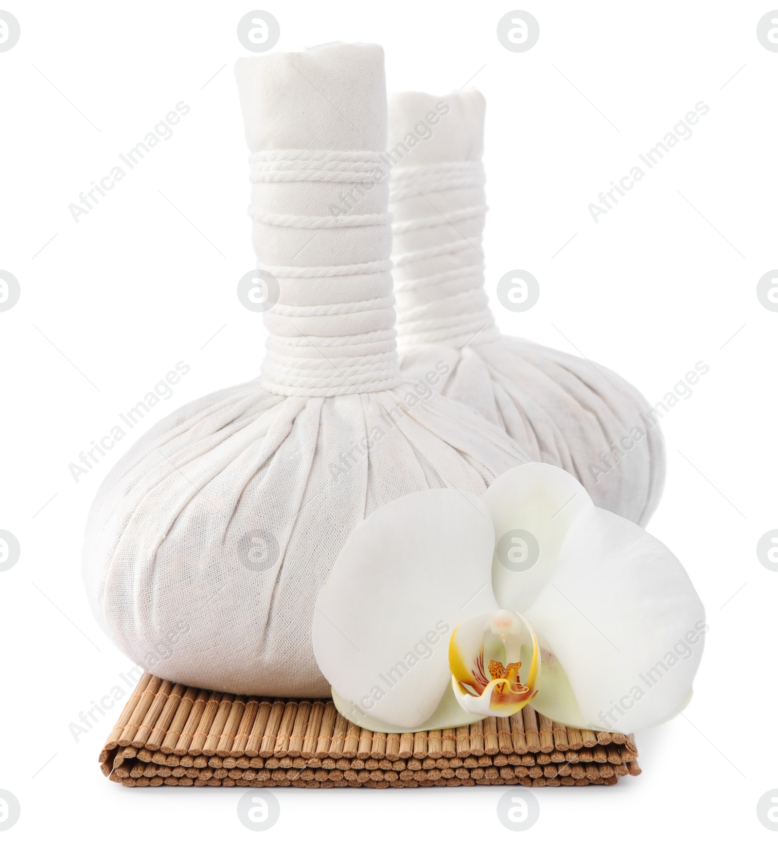 Photo of Herbal massage bags and flower on white background. Spa supply