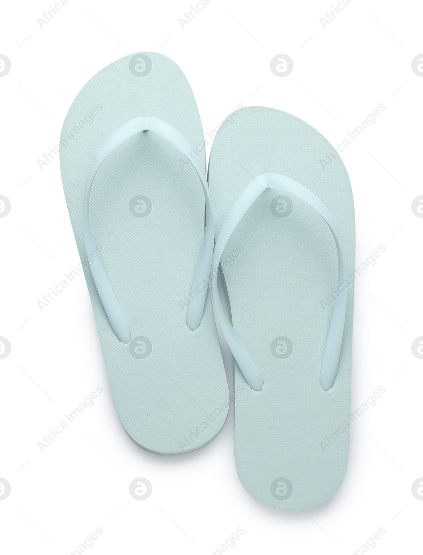 Photo of Stylish light blue flip flops on white background, top view. Beach object