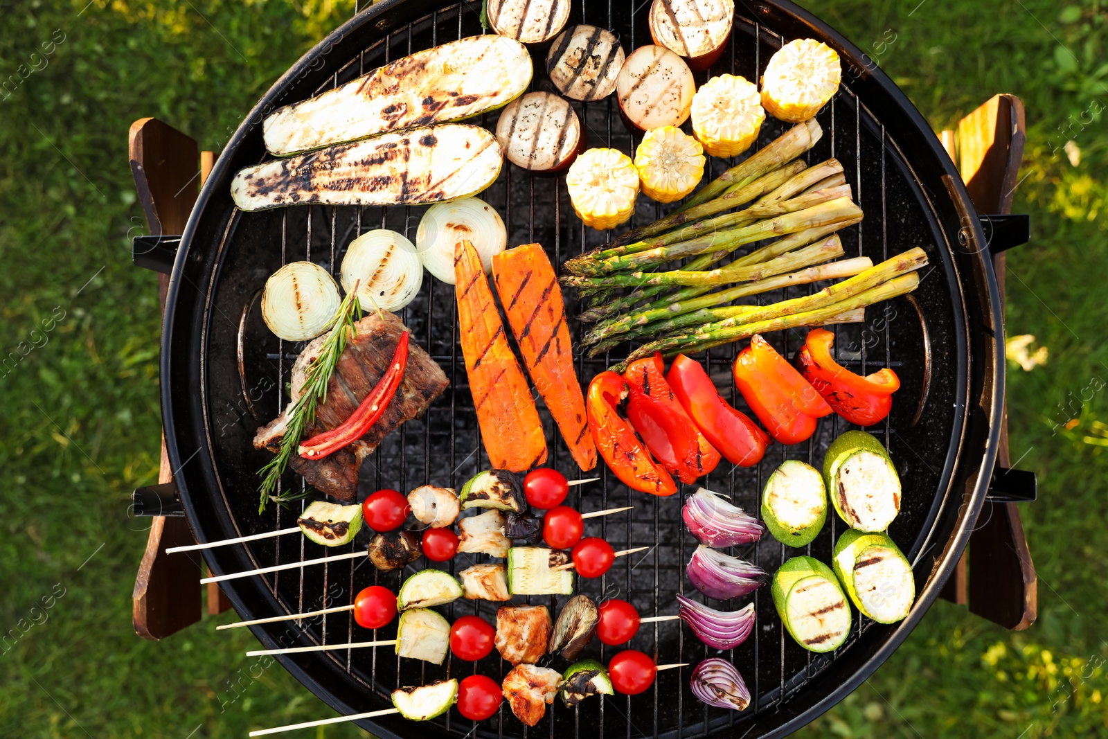 Photo of Delicious grilled vegetables on barbecue grill outdoors, top view