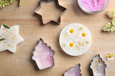 Photo of Flat lay composition with handmade candles on wooden background