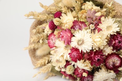 Beautiful bouquet of dry flowers on white background, closeup