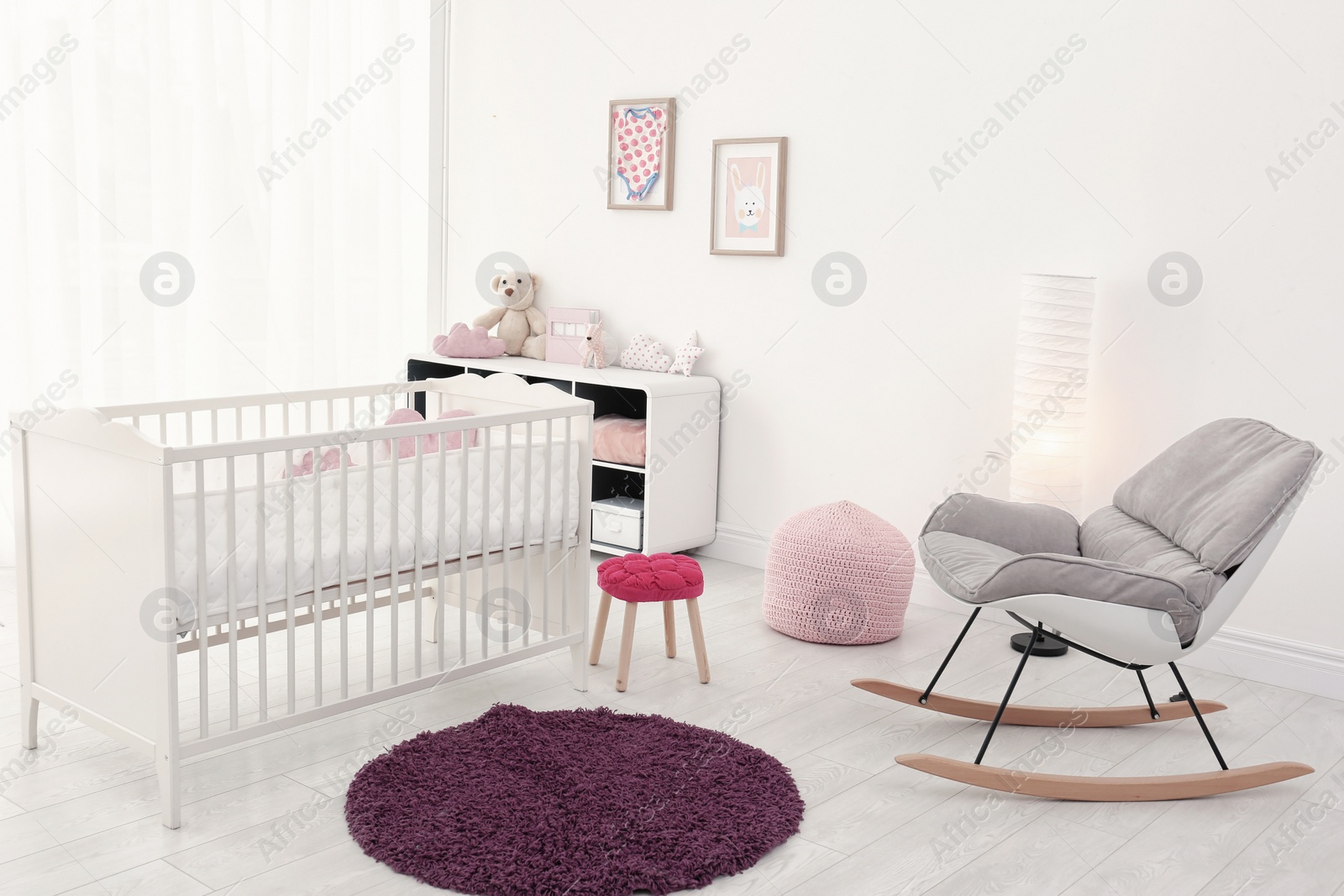 Photo of Baby room interior with comfortable crib and rocking chair