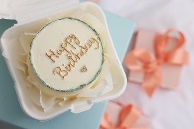 Photo of Delicious decorated Birthday cake on light blue surface, top view. Space for text