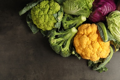 Photo of Different fresh cabbages on table, top view. Healthy food