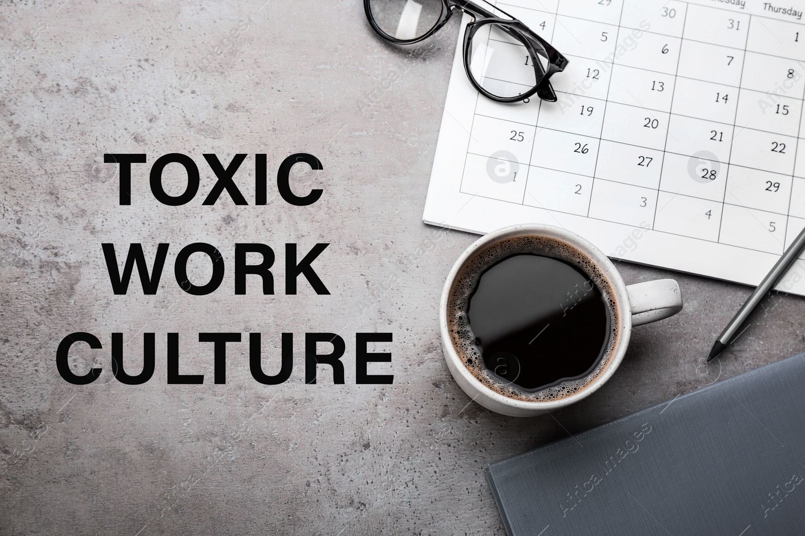 Image of Cup of coffee, computer keyboard, stationery and text TOXIC WORK CULTURE on grey table, flat lay 