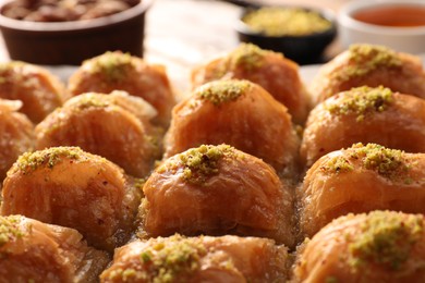 Photo of Delicious sweet baklava with pistachios on table, closeup